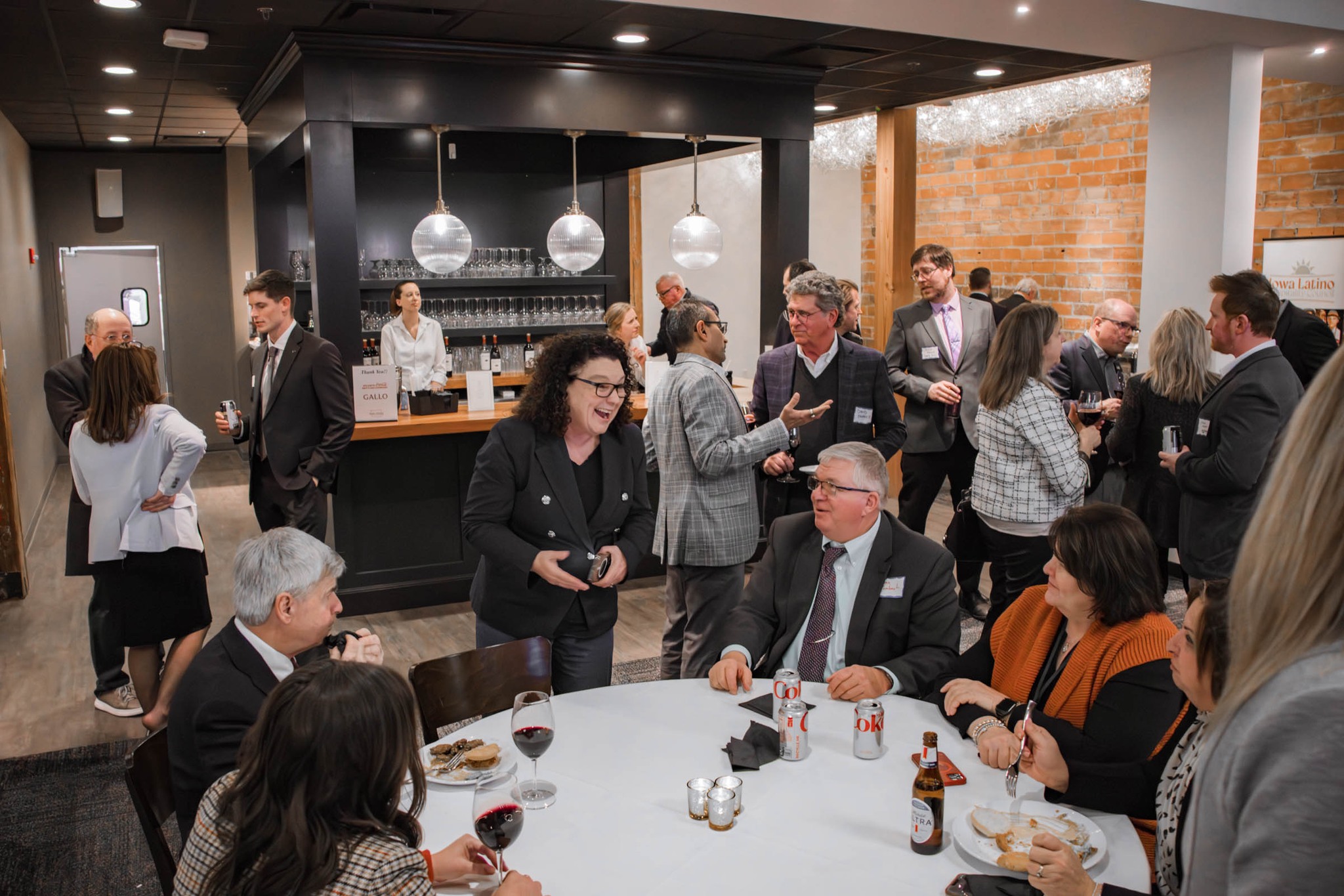 Guests talking and networking at a reception with bar service.