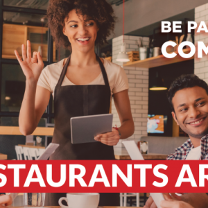 Group of friends greeted by a server at a restaurant with bold banner text reading “Iowa Restaurants Are Hiring – Be Part of Our Comeback.”